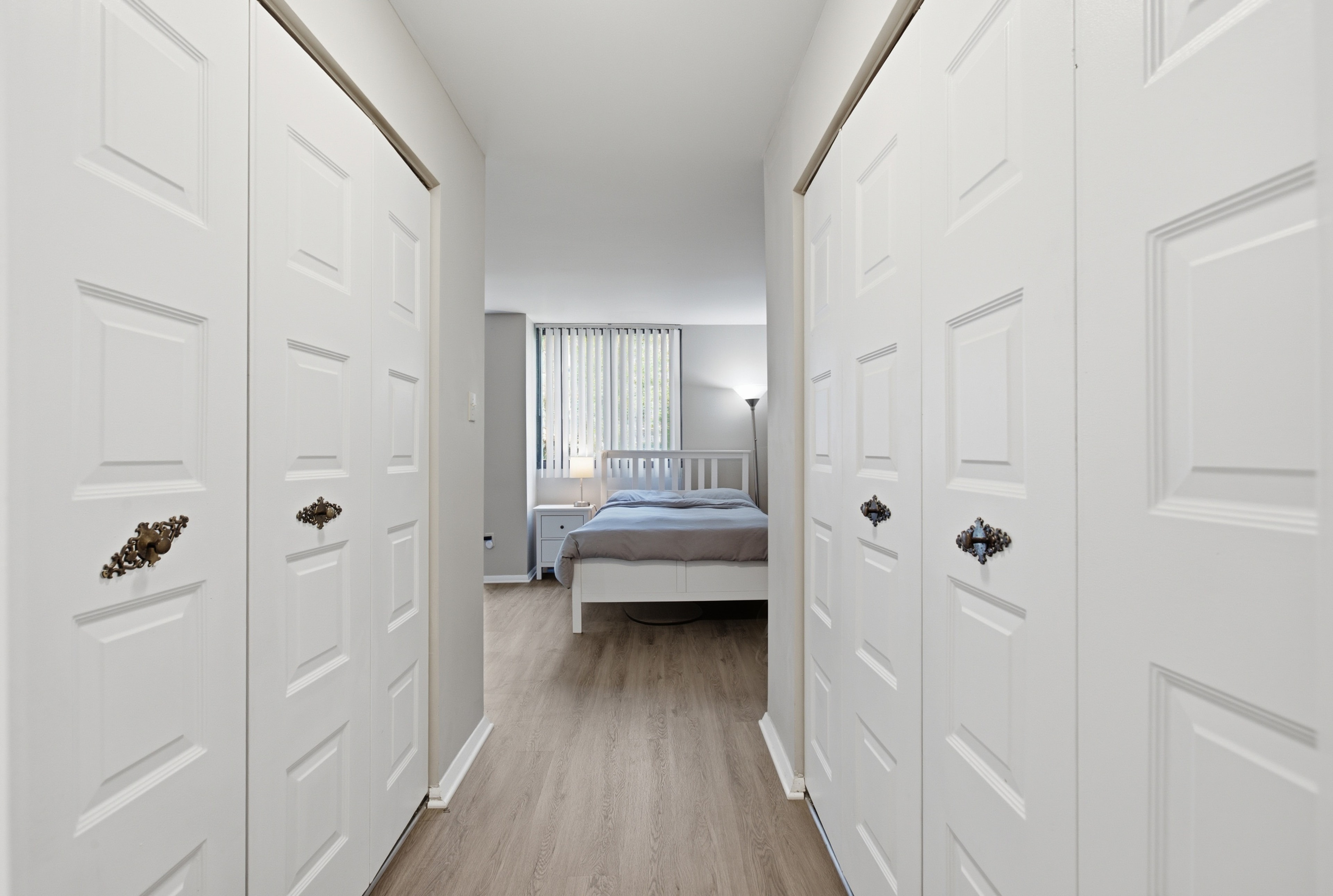 Hallway with dual closets leading to sleeping area