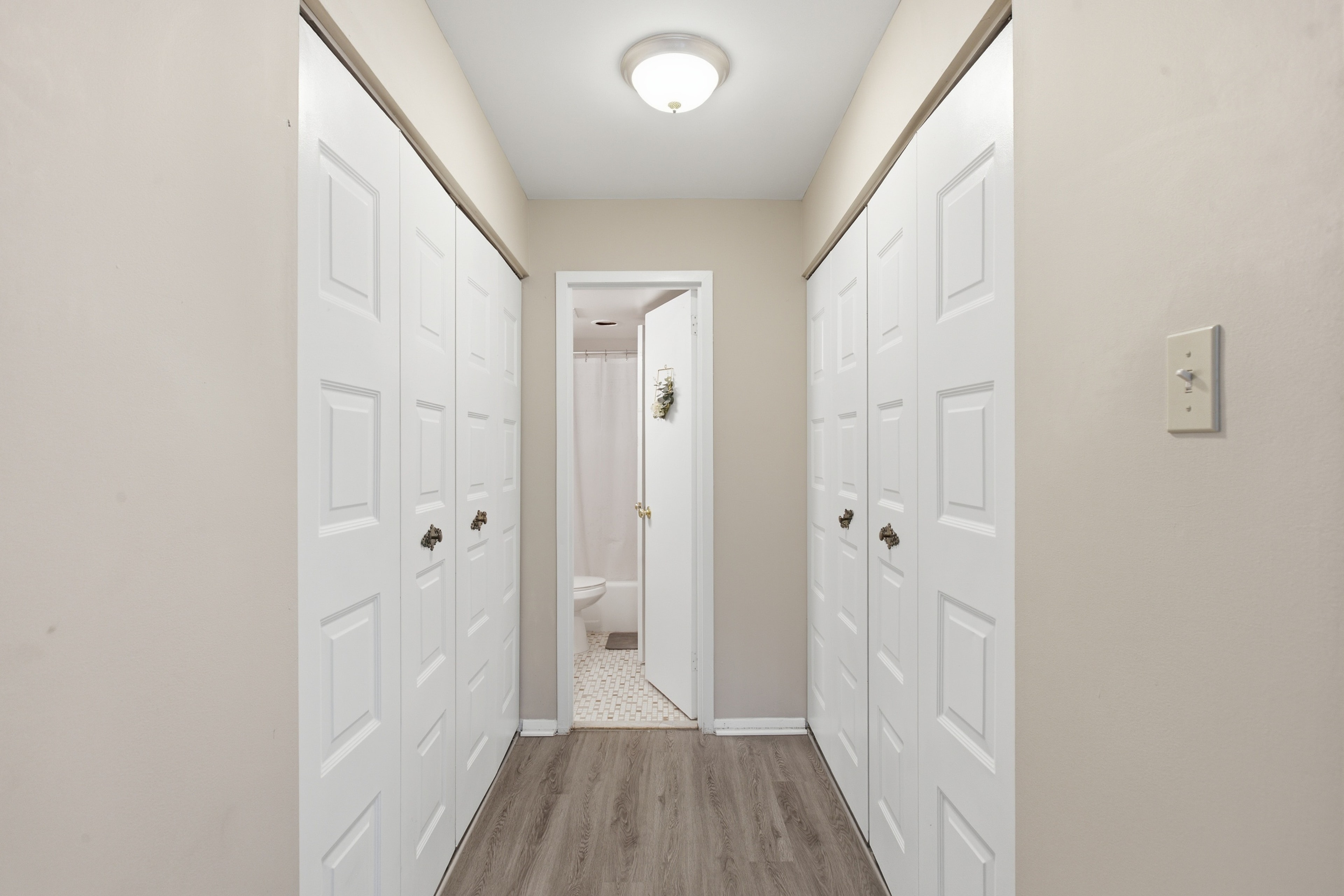 Entry hallway with closets and bathroom access