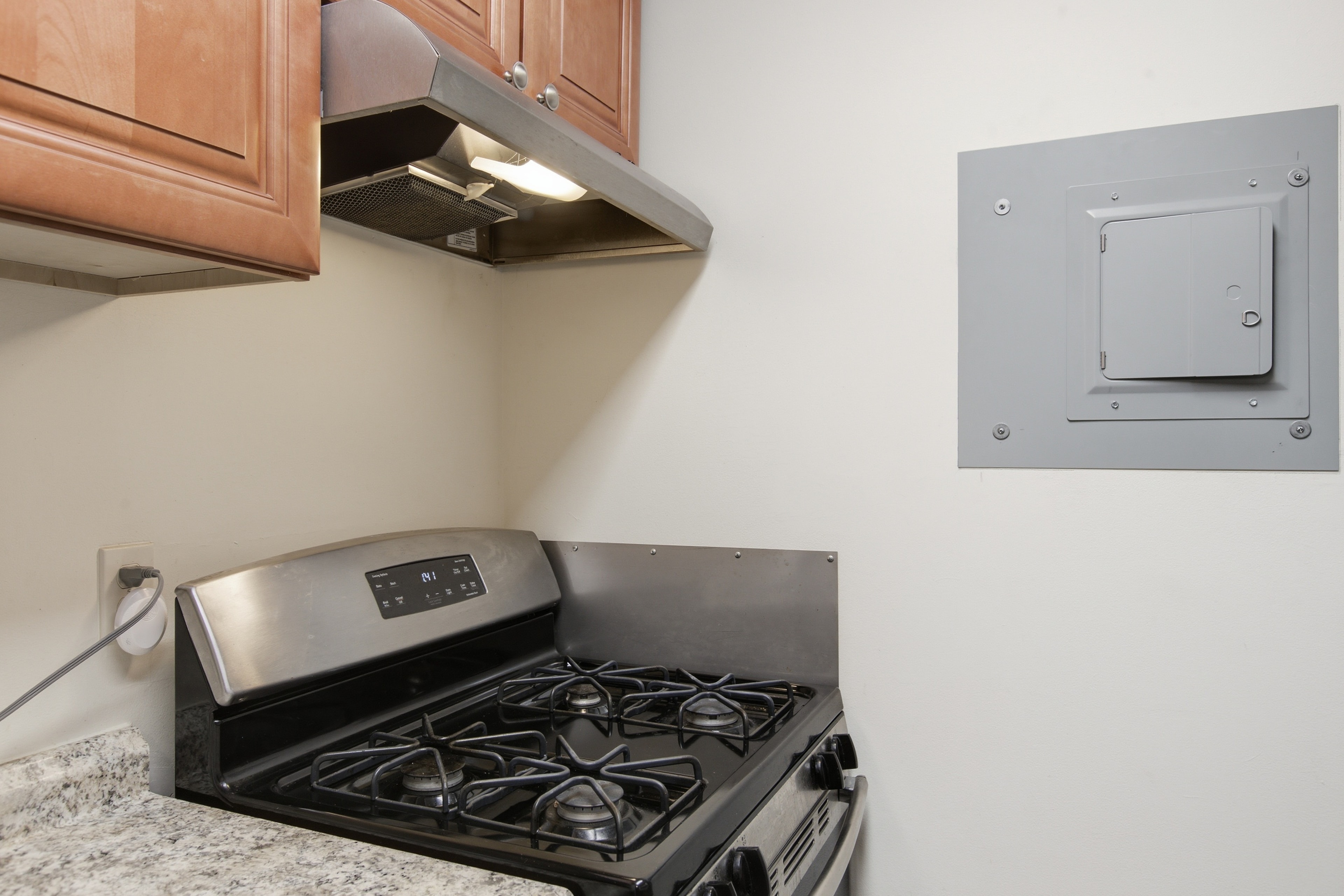 Gas range and wood cabinetry detail